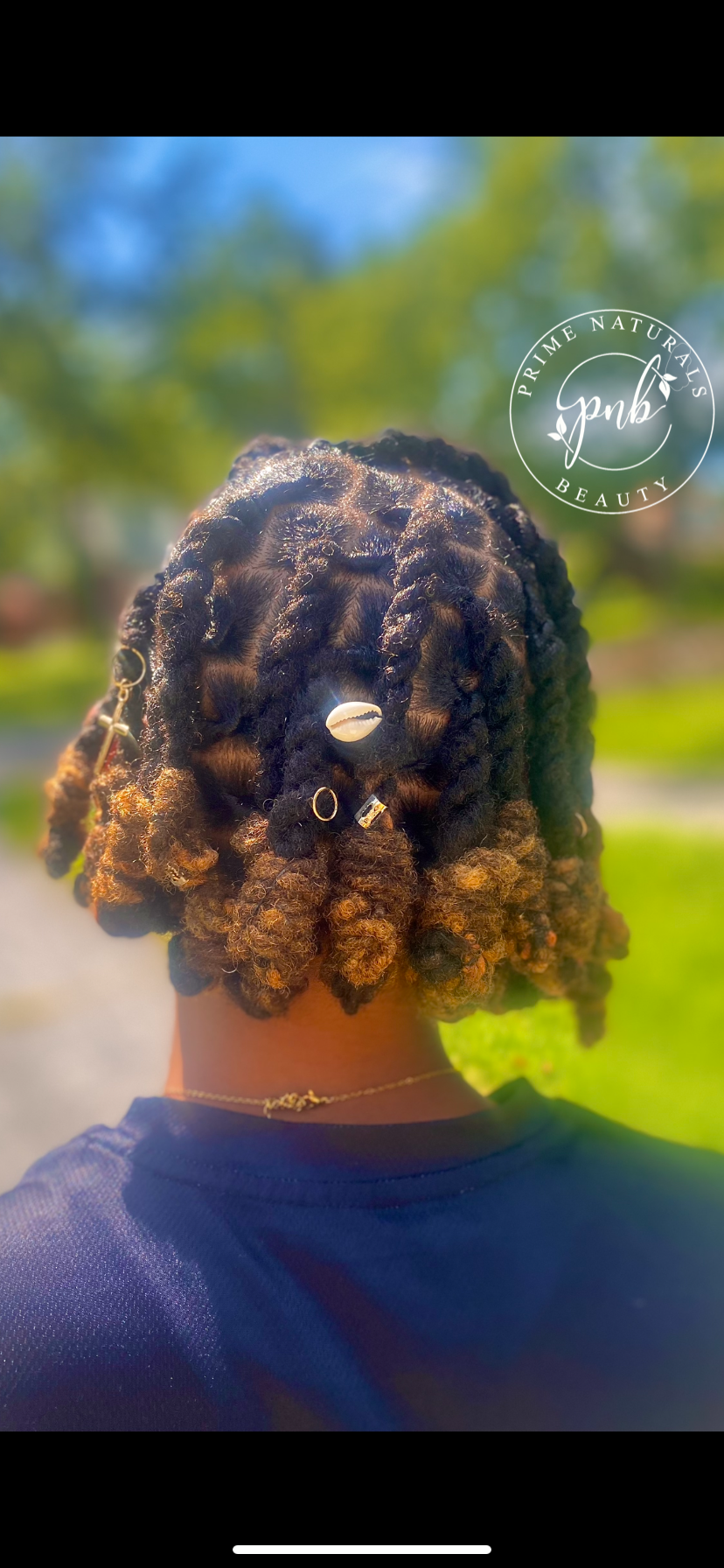 Natural protective hairstyle ; Loc Knot BoB . Medium to long locs two strand twisted then wrapped up at the end into what looks like a knot. 